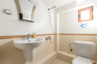 a bathroom with a sink and a toilet at Chalet Mila - Total Chalets - Fully Catered in Bansko