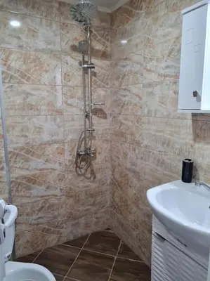 a bathroom with a shower and a toilet and a sink at Вила Вайлин in Batak