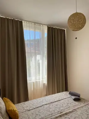 a bedroom with a bed and a large window at Barceló Apartment Velingrad in Velingrad