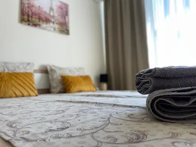 a bedroom with a bed with towels on it at Barceló Apartment Velingrad in Velingrad