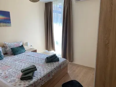 a bedroom with a bed with two bags on it at Barceló Apartment Velingrad in Velingrad