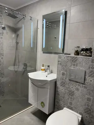 a bathroom with a toilet and a sink and a shower at Barceló Apartment Velingrad in Velingrad