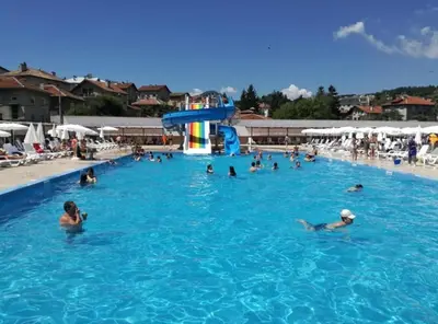 a group of people swimming in a swimming pool at Barceló Apartment Velingrad in Velingrad
