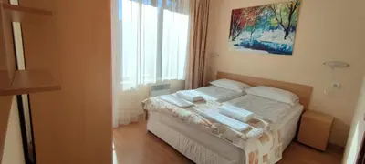 a bedroom with a bed with white sheets and a window at Apartment SUNNY&RELAX Pamporovo The Castle 2 in Pamporovo