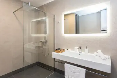 a bathroom with a sink and a shower at Complex Gallery Vitosha **** in Sofia