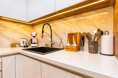 a kitchen with white counters and a sink at 'Little Little' House in the town CENTER & PARKING in Plovdiv