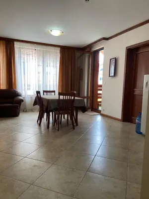 a living room with a table and chairs at Luxory aparthotel in 4 star SPA hotel st Ivan Rilski, Bansko in Bansko