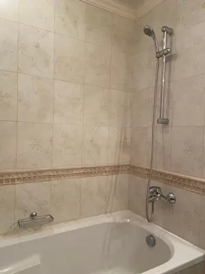 a bathroom with a bath tub with a shower at Luxory aparthotel in 4 star SPA hotel st Ivan Rilski, Bansko in Bansko