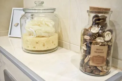 two glass jars sitting on a counter with a cake at Duplex Condo Prime Location 2BTH 2 Studios in Sofia