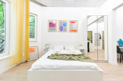 a bedroom with a large white bed in a room at Duplex Condo Prime Location 2BTH 2 Studios in Sofia