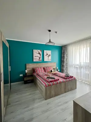 a bedroom with a bed and a blue wall at Flower house 7 in Sofia