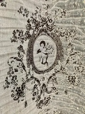 an embroidery of a child in a frame on a blanket at Flower house 7 in Sofia