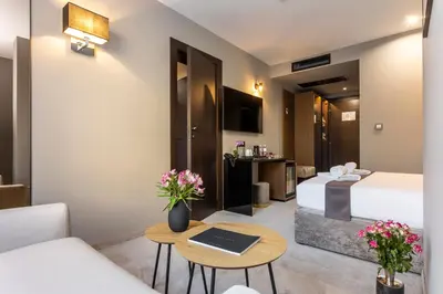 a hotel room with a bed and a table at Abrazo Sofia Hotel by HMG in Sofia