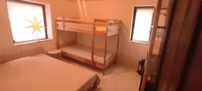 a small room with two bunk beds and two windows at Marina apartment in Stoykite