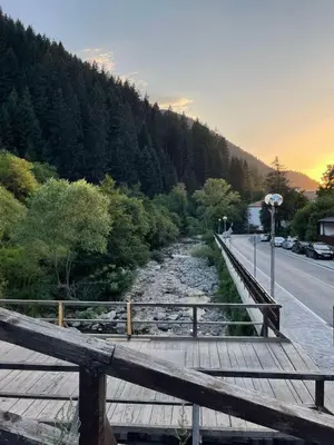 a wooden bridge over a river next to a road at Marina apartment in Stoykite