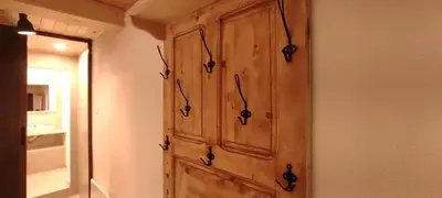 a wooden cabinet on a wall in a room at Marina apartment in Stoykite