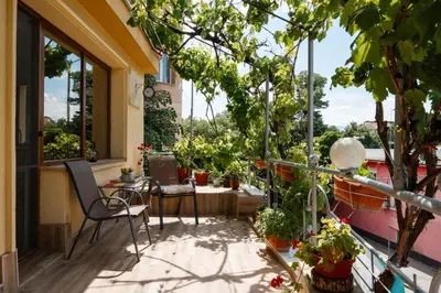 a balcony with a table and chairs and plants at Cozy Apartment Green Terrace in Plovdiv