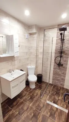 a bathroom with a toilet and a sink and a shower at Апартамент Relax in Smolyan