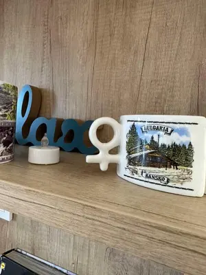 a coffee cup and a pair of scissors on a shelf at Boutique apartment Bansko Bell Tower in Bansko