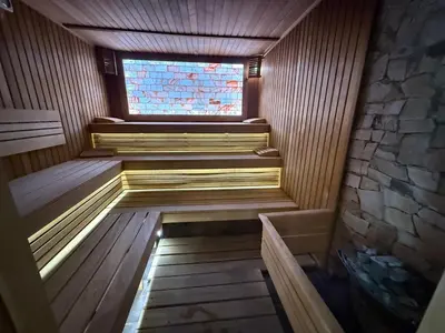 a sauna with a window and stairs in it at Мия 2 Спа хотел Свети Спас in Velingrad