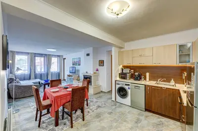a kitchen and dining room with a table and chairs at Bright and Spacious 2-BDR Apartment with Balcony by Flat Mаnager in Pamporovo