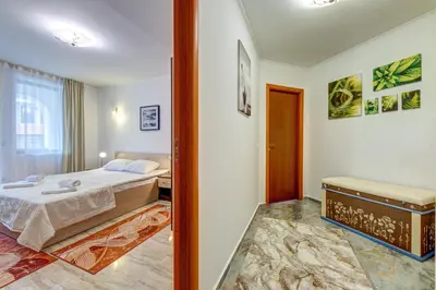 a small bedroom with a bed and a window at Bright and Spacious 2-BDR Apartment with Balcony by Flat Mаnager in Pamporovo