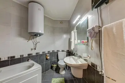 a small bathroom with a sink and a toilet at Bright and Spacious 2-BDR Apartment with Balcony by Flat Mаnager in Pamporovo