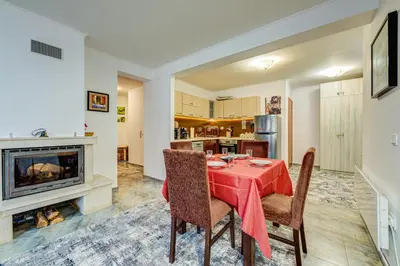 a dining room with a table and chairs and a fireplace at Bright and Spacious 2-BDR Apartment with Balcony by Flat Mаnager in Pamporovo
