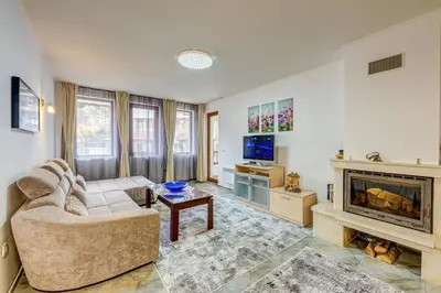 a living room with a couch and a fireplace at Bright and Spacious 2-BDR Apartment with Balcony by Flat Mаnager in Pamporovo