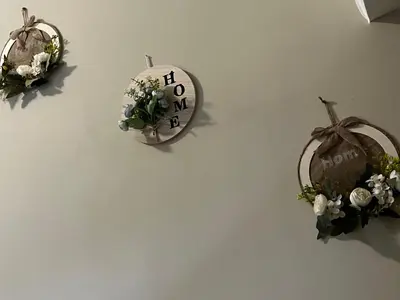 a white wall with flowers and a clock on it at Guest House Tatiana Studio in Petrich