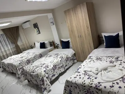 a hotel room with two beds in a room at Guest House Tatiana Studio in Petrich