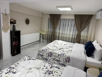 a bedroom with two beds with towels on them at Guest House Tatiana Studio in Petrich