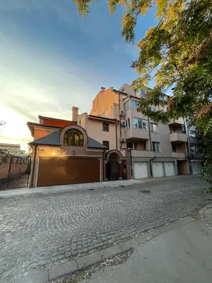 a house with a garage on a cobblestone street at Апартамент Ламартин- в сърцето на Пловдив in Plovdiv