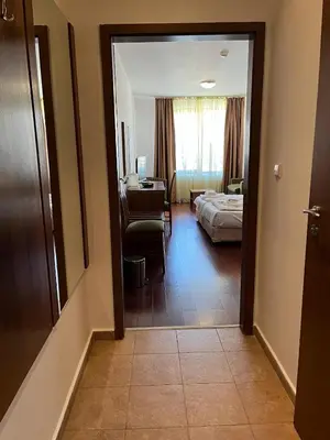 a room with a bedroom and a bed and a mirror at Ski & Relax Apartments in Bellevue Residence in Bansko