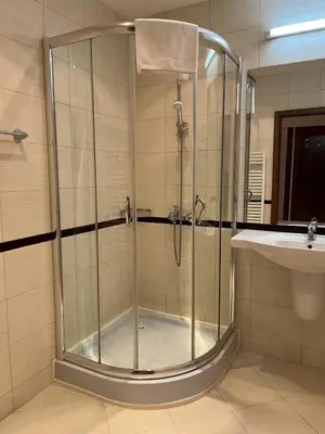 a shower stall in a bathroom with a sink at Ski & Relax Apartments in Bellevue Residence in Bansko