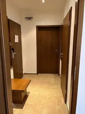an empty hallway with a door and a wooden floor at Ski & Relax Apartments in Bellevue Residence in Bansko