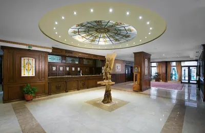 a lobby with a statue in the middle of a building at Мия 3 Спа хотел Свети Спас in Velingrad