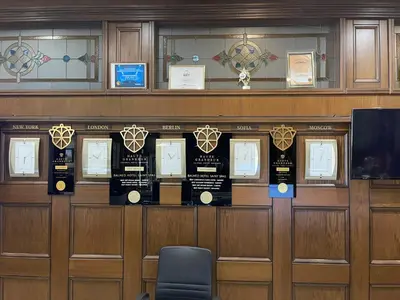 a room with a row of wooden doors withaques on them at Мия 3 Спа хотел Свети Спас in Velingrad