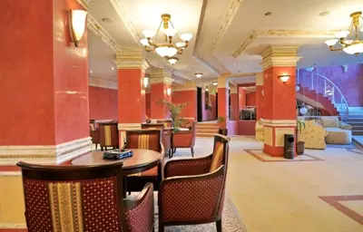 a hotel lobby with a table and chairs at Apartment Sam in Grand Monastery in Pamporovo