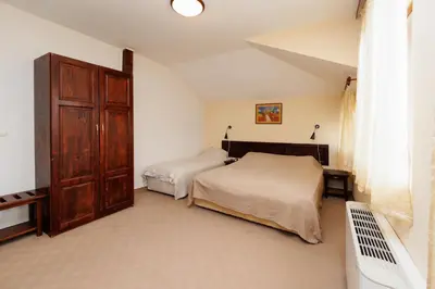 a bedroom with two beds and a large closet at Конна база и Къща за гости Дворене in Razlog