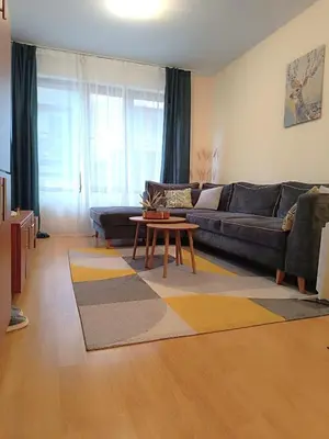 a living room with a couch and a coffee table at Bansko Apartment Predela the One in Bansko