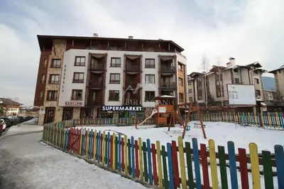 a colorful fence in front of a building at Bansko Apartment Predela the One in Bansko