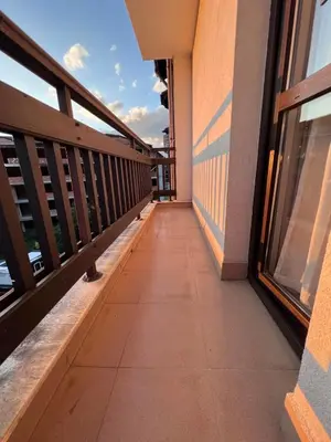 a balcony of a building with a walkway at Jordan Apartment’s Bansko in Bansko