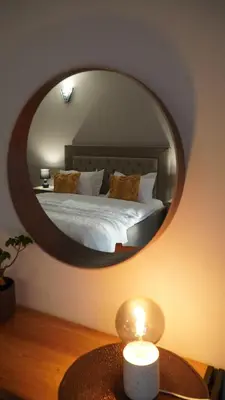 a bedroom with a bed with a large mirror at Villa Manevi in Yavornitsa
