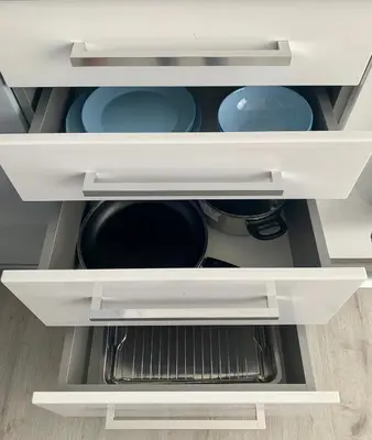 a kitchen drawer with plates and bowls in it at Blue loft & 2bedrooms & parking in Sofia