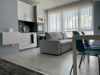 a living room with a couch and a table at Blue loft & 2bedrooms & parking in Sofia