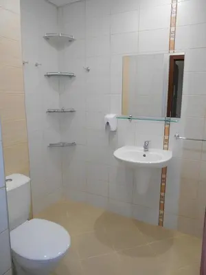 a white bathroom with a toilet and a sink at NEAT STUDIOS in 