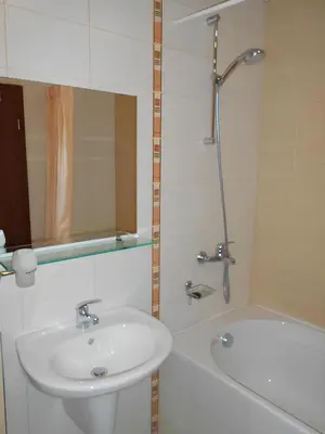 a bathroom with a sink and a shower and a tub at NEAT STUDIOS in 
