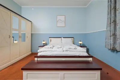 a bedroom with a bed with a wooden table at Life in Colors - Elegant 2BD Premium Stay by Flat Mаnager in Sofia