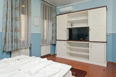 a bedroom with a bed and a tv in a room at Life in Colors - Elegant 2BD Premium Stay by Flat Mаnager in Sofia